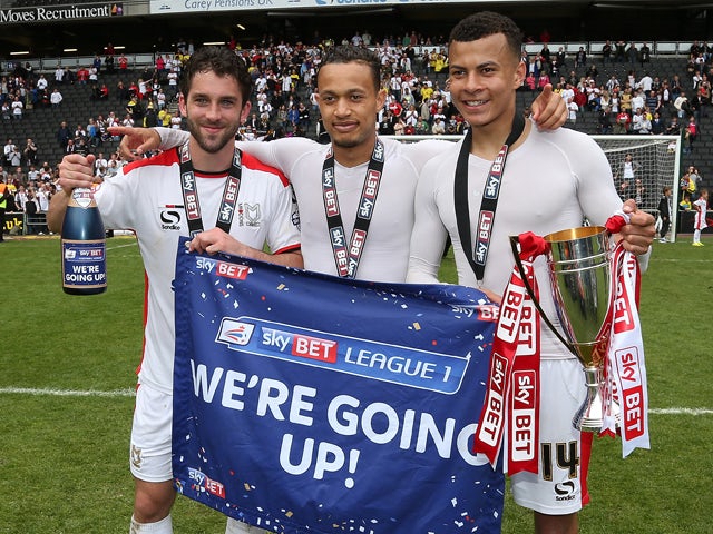 Will Grigg,Dele Alli and Lewis Baker of MK Dons celebrate after gaining promotion to the Championship at the end of the Sky Bet League One match between MK Dons and Yeovil Town at Stadium mk on May 3, 2015