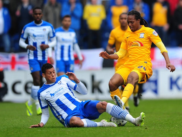 Daniel Johnson of Preston North End battles for the ball with Matt Briggs of Colchester United during the Sky Bet League One match between Colchester United and Preston North End at Colchester Community Stadium on May 3, 2015