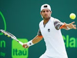 Simone Bolelli of Italy returns the ball to Marcos Baghdatis of Cyprus during day 4 of the Miami Open at Crandon Park Tennis Center on March 26, 2015