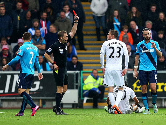 Marc Wilson of Stoke City is shown the red card by referee Craig Pawson during the Barclays Premier League match between Swansea City and Stoke City at Liberty Stadium on May 2, 2015 