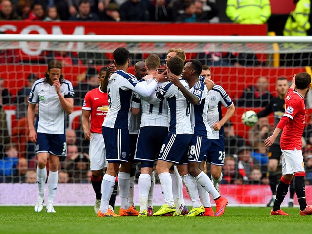 Chris Brunt of West Brom celebrates with team-mates after taking a free-kick which was deflected off Jonas Olsson of West Brom to score the opening goal during the Barclays Premier League match between Manchester United and West Bromwich Albion at Old Tra