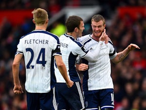 Chris Brunt of West Brom celebrates with team-mates Craig Gardner and Darren Fletcher after taking a free-kick which was deflected off Jonas Olsson of West Brom to score the opening goal during the Barclays Premier League match between Manchester United a