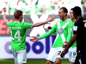 Wolfsburg's Dutch striker Bas Dost celebrates after scoring his team's opening goal during the German first division Bundesliga football match between VfL Wolfsburg and Hannover 96 at the Volkswagen Arena in Wolfsburg, central Germany, on May 2, 2015