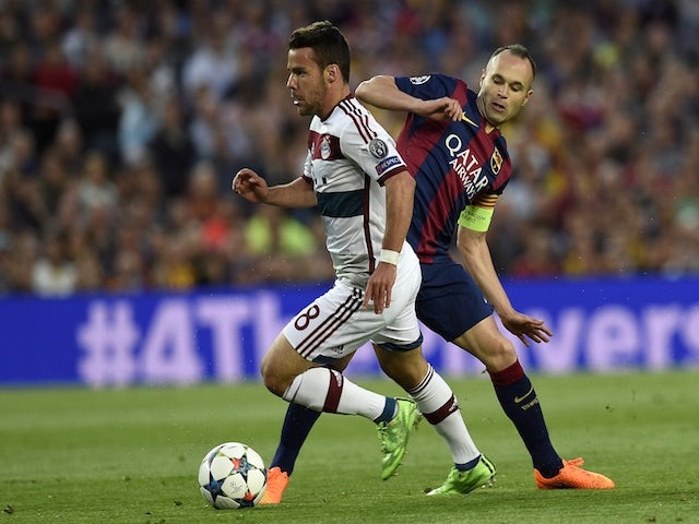 Barcelona's midfielder Andres Iniesta (R) vies with Bayern Munich's Spanish defender Juan Bernat (L) during the UEFA Champions League football match FC Barcelona vs FC Bayern Muenchen at the Camp Nou stadium in Barcelona on May 6, 2015