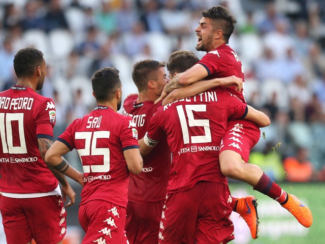 Cagliari's defender Luca Rossettini celebrates with teammates after scoring a goal during the Italian Serie A football match Juventus vs Cagliari on May 9, 2015