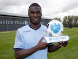 Christian Benteke poses with his player of the month award for April 2015