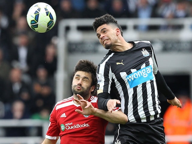 Newcastle United's French striker Emmanuel Riviere (R) challenges West Bromwich Albion's Argentinian midfielder Claudio Yacob (L) during the English Premier League football match between Newcastle United and West Bromwich Albion at St James Park, Newcastl