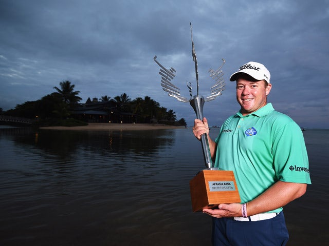 George Coetzee of South Africa with the trophy after winning the AfrAsia Bank Mauritius Open at Heritage Golf Club on May 10, 2015