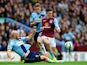 Jack Grealish of Aston Villa is tackled by James Collins of West Ham United during the Barclays Premier League match between Aston Villa and West Ham United at Villa Park on May 9, 2015