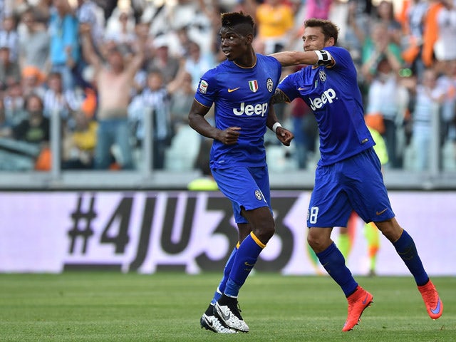 Paul Pogba of Juventus FC celebrates the opening goal with team mate Claudio Marchisio during the Serie A match between Juventus FC and Cagliari Calcio at Juventus Arena on May 09, 2015