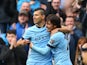 Sergio Aguero of Manchester City is congratulated by teammate David Silva of Manchester City after scoriing the opening goal during the Barclays Premier League match between Manchester City and Queens Park Rangers at the Etihad Stadium on May 10, 2015