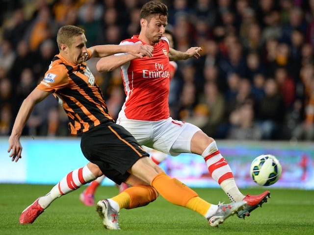 Hull defender Michael Dawson challenges Arsenal's Olivier Giroud during the Premier League match on May 4, 2015