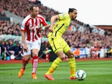Nacer Chadli of Tottenham Hotspur is closed down by Charlie Adam of Stoke City during the Barclays Premier League match between Stoke City and Tottenham Hotspur at Britannia Stadium on May 9, 2015