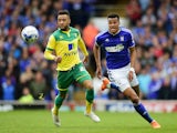 Nathan Redmond of Norwich closes down Tyrone Mings of Ipswich during the Sky Bet Championship Playoff semi-final first leg match between Ipswich Town and Norwich Cityat Portman Road on May 9, 2015