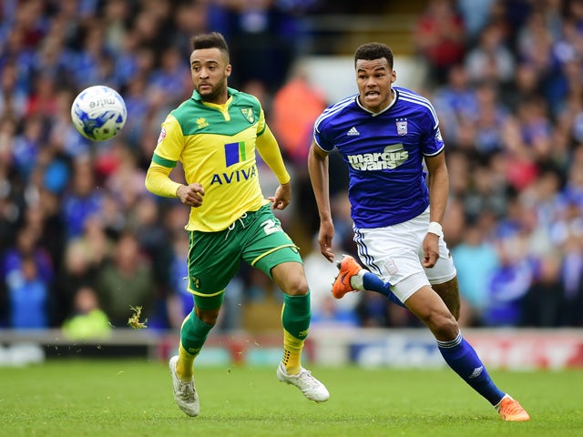Nathan Redmond of Norwich closes down Tyrone Mings of Ipswich during the Sky Bet Championship Playoff semi-final first leg match between Ipswich Town and Norwich Cityat Portman Road on May 9, 2015
