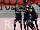 Reim's players celebrates after scoring a goal during the French L1 football match between Evian and Reims on May 9, 2015