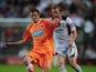 Tom Barkhuizen of Blackpool shields the ball from Dean Lewington of MK Dons during the Carling Cup 2nd Round match between MK Dons and Blackpool at Stadium MK on August 24, 2010