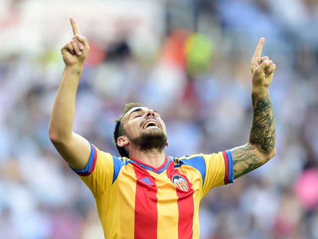 Valencia's forward Paco Alcacer celebrates after scoring during the Spanish league football match Real Madrid CF vs Valencia CF at the Santiago Bernabeu stadium in Madrid on May 9, 2015