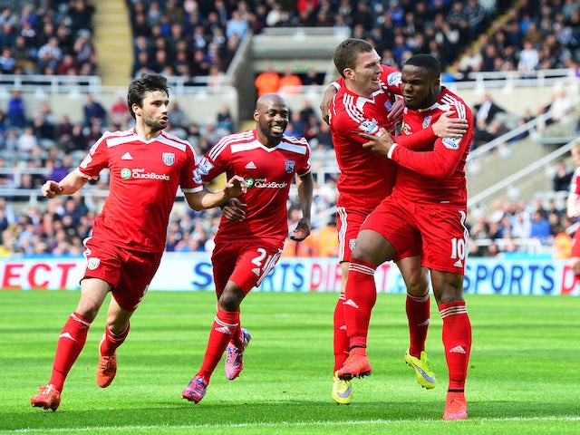  Victor Anichebe of West Brom celebrates scoring the opening goal with team mates during the Barclays Premier League match between Newcastle United and West Bromwich Albion at St James' Park on May 9, 2015