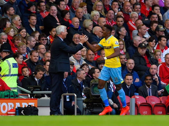 Manager Alan Pardew of Crystal Palace congratulates Wilfried Zaha of Crystal Palace on scoring their second goal during the Barclays Premier League match between Liverpool and Crystal Palace at Anfield on May 16, 2015