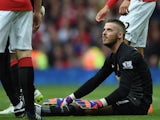 Manchester United's Spanish goalkeeper David de Gea lies on the ground after being injured during the English Premier League football match between Manchester United and Arsenal at Old Trafford in Manchester, northwest England, on May 17, 2015