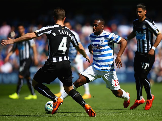 David Hoilett of QPR and Ryan Taylor of Newcastle United compete for the ball during the Barclays Premier League match between Queens Park Rangers and Newcastle United at Loftus Road on May 16, 2015