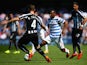 David Hoilett of QPR and Ryan Taylor of Newcastle United compete for the ball during the Barclays Premier League match between Queens Park Rangers and Newcastle United at Loftus Road on May 16, 2015