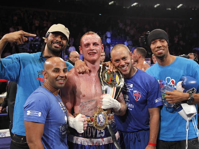 George Groves (C) celebrates with David Haye (L) after winning his fight against James DeGale, during their British and Commonwealth Super-Middleweight Championship title boxing fight at the O2 Arena, in London on May 21, 2011