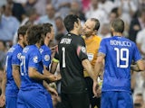 Juventus' goalkeeper and captain Gianluigi Buffon (C) argues with the referee during the UEFA Champions League semifinal second leg football match Real Madrid FC vs Juventus at the Santiago Bernabeu stadium in Madrid on May 13, 2015