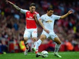 Hector Bellerin of Arsenal and Jefferson Montero of Swansea City battle for the ball during the Barclays Premier League match between Arsenal and Swansea City at Emirates Stadium on May 11, 2015