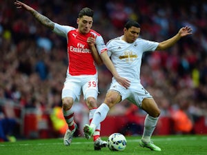 Hector Bellerin of Arsenal and Jefferson Montero of Swansea City battle for the ball during the Barclays Premier League match between Arsenal and Swansea City at Emirates Stadium on May 11, 2015