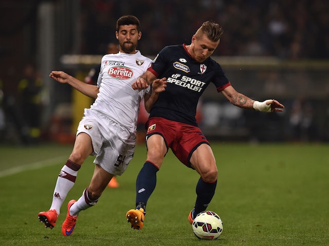 Juraj Kucka (L) of Genoa CFC is challenged by Marco Benassi of Torino FC during the Serie A match between Genoa CFC and Torino FC at Stadio Luigi Ferraris on May 11, 2015