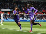 Yaya Toure of Manchester City is congratulated by teammate Jesus Navas of Manchester City after scoring his team's third goal during the Barclays Premier League match between Swansea and Manchester City at the Liberty Stadium on May 17, 2015
