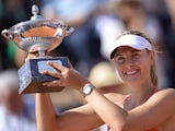 Maria Sharapova of Russia holds her trophy after winning the women's final match against Carla Suarez Navarro of Spain during at the WTA Tennis Open on May 17, 2015