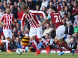 Marko Arnautovic of Stoke City and George Boyd of Burnley compete for the ball during the Barclays Premier League match between Burnley and Stoke City at Turf Moor on May 16, 2015