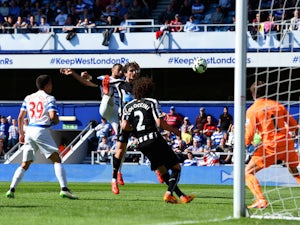 Matt Philips of QPR scores their first goal under pressure from Fabricio Coloccini of Newcastle United during the Barclays Premier League match between Queens Park Rangers and Newcastle United at Loftus Road on May 16, 2015