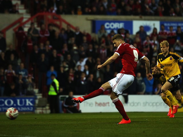 Michael Smith of Swindon Town scores from a penalty during the Sky Bet League 1 Playoff Semi-Final between Swindon Town and Sheffiled United at County Ground on May 11, 2015