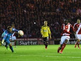 Albert Adomah of Middlesbrough shoots past goalkeeper David Button of Brentford to score their third goal during the Sky Bet Championship Playoff semi final second leg match between Middlesbrough and Brentford at the Riverside Stadium on May 15, 2015