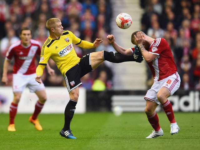 Jake Bidwell of Brentford challenges Adam Clayton of Middlesbrough during the Sky Bet Championship Playoff semi final second leg match between Middlesbrough and Brentford at the Riverside Stadium on May 15, 2015