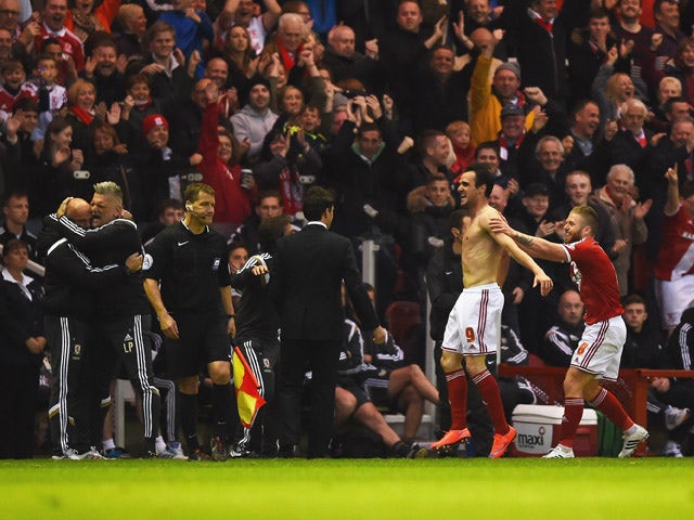 Enrique Garcia Kike of Middlesbrough (9) celebrates with the team bench as he scores their second goal during the Sky Bet Championship Playoff semi final second leg match between Middlesbrough and Brentford at the Riverside Stadium on May 15, 2015