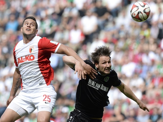 Augsburg's Argentinian striker Raul Bobadilla (L) and Hanover's defender Christian Schulz (R) vie for the ball during the German first division Bundesliga football match FC Augsburg vs Hannover 96 in Augsburg, southern Germany, on May 16, 2015