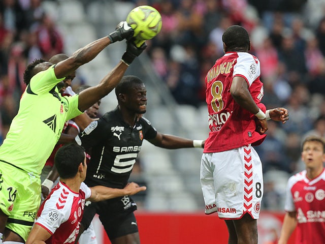 Reims' Togolese goalkeeper Kossi Agassa catches the ball in front of Rennes' Senegalese defender Fallou Diagne during the L1 match Reims and Rennes on May 16, 2015