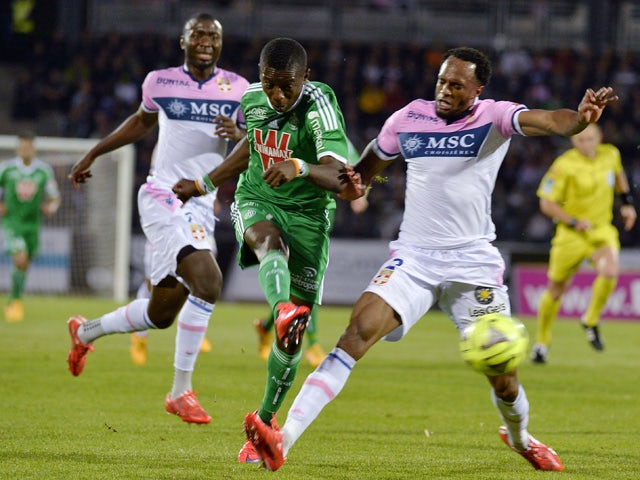 Saint-Etienne's Ivorian forward Max-Alain Gradel shoots to score between Evian's Congolese defender Cedric Mongongu and Evian's Comorian defender Kassim Abdallah during the French L1 football match between Evian Thonon Gaillard (ETG) and Saint-Etienne (AS