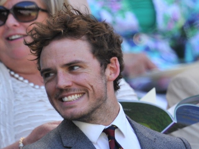 Sam Claflin and Laura Haddock sit in the royal box on Centre Court as they wait for the start of the women's singles semi-final matches on day ten of the 2014 Wimbledon Championships at The All England Tennis Club in Wimbledon, southwest London, on July 3