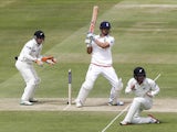 Englands Captain Alastair Cook (2nd L) hits a shot for 4 runs watched by New Zealands wicketkeeper Tom Latham (L) during play on the fourth day of the first cricket Test match between England and New Zealand at Lord's cricket ground in London on May 24, 2