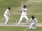 Englands Captain Alastair Cook (2nd L) hits a shot for 4 runs watched by New Zealands wicketkeeper Tom Latham (L) during play on the fourth day of the first cricket Test match between England and New Zealand at Lord's cricket ground in London on May 24, 2