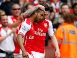 Theo Walcott of Arsenal scores his team's first goal during the Barclays Premier League match between Arsenal and West Bromwich Albion at Emirates Stadium on May 24, 2015