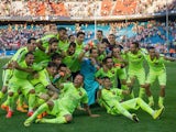 Barcelona players celebrate at the Vicente Calderon after beating Atletico Madrid 1-0 to clinch the 2014-15 La Liga title on May 17, 2015