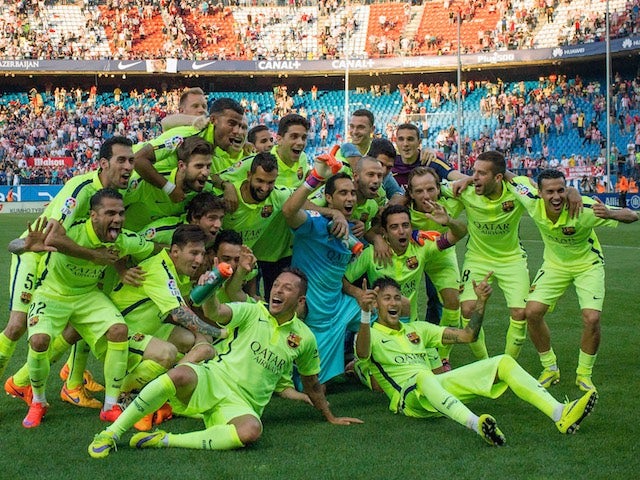 Barcelona players celebrate at the Vicente Calderon after beating Atletico Madrid 1-0 to clinch the 2014-15 La Liga title on May 17, 2015