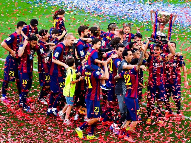 FC Barcelona players celebrate with La Liga trophy at the end of the La Liga match between FC Barcelona and RC Deportivo de la Coruna at Camp Nou on May 23, 2015